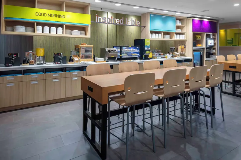 Breakfast counter and communal table. Home2 Suites by Hilton, Lynchburg, VA