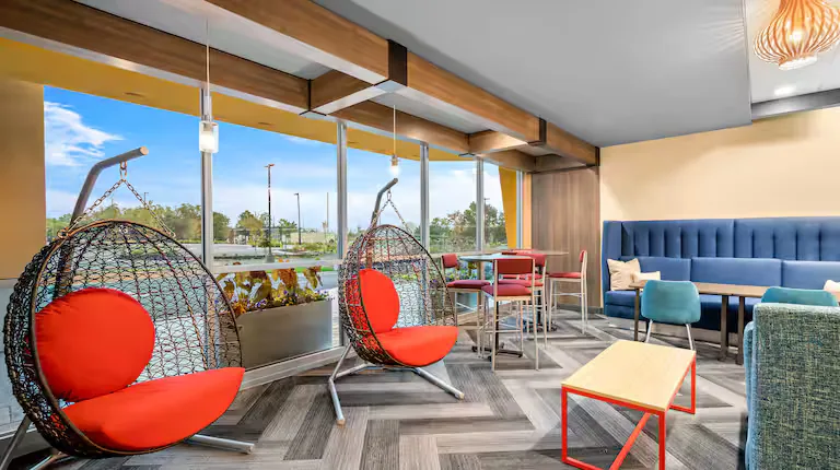 Lobby lounge with hanging chairs. Tru by Hilton, Lexington, VA