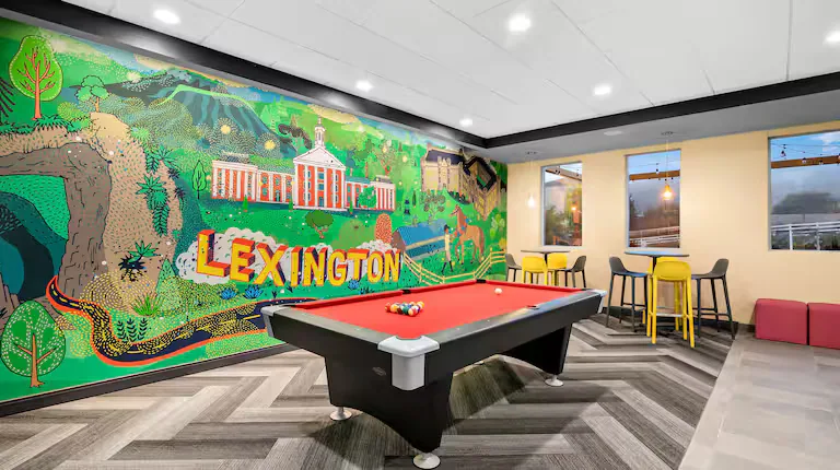 Game area with pool table and Lexington mural. Tru by Hilton, Lexington, VA