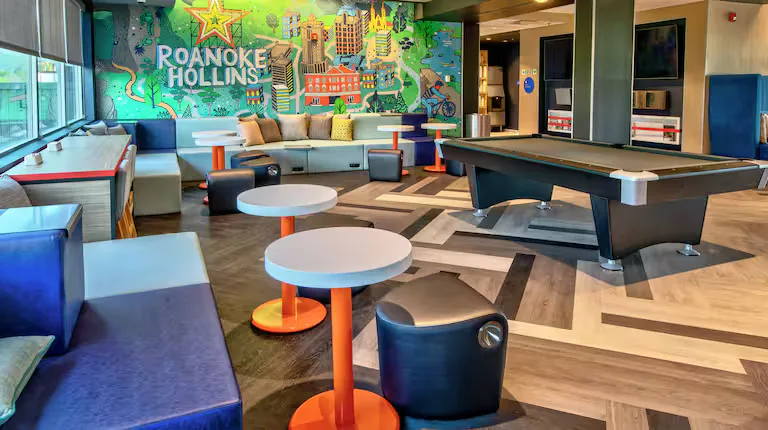 Game area with pool table and Roanoke mural. Tru by Hilton, Roanoke, VA