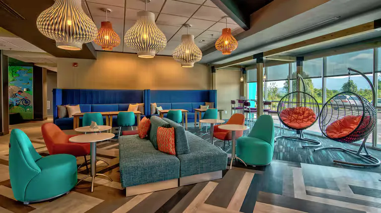 Lobby lounge with hanging chairs. Tru by Hilton, Roanoke, VA